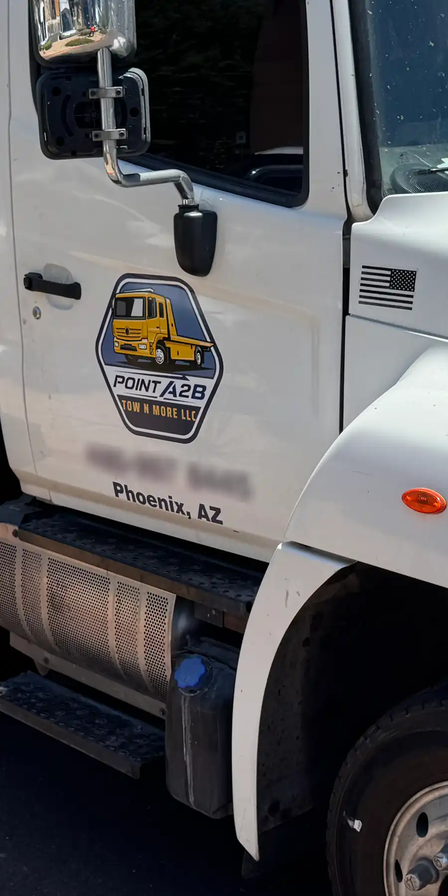 Point A2B Tow N' More flatbed tow truck with the Point A2B logo on the door